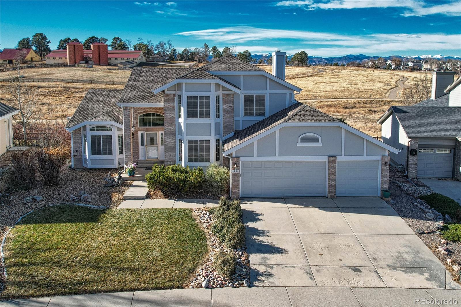 9858 Venneford Ranch Road Highlands Ranch, CO 80126 - Photo 1 of 50 a front view of a house with a yard