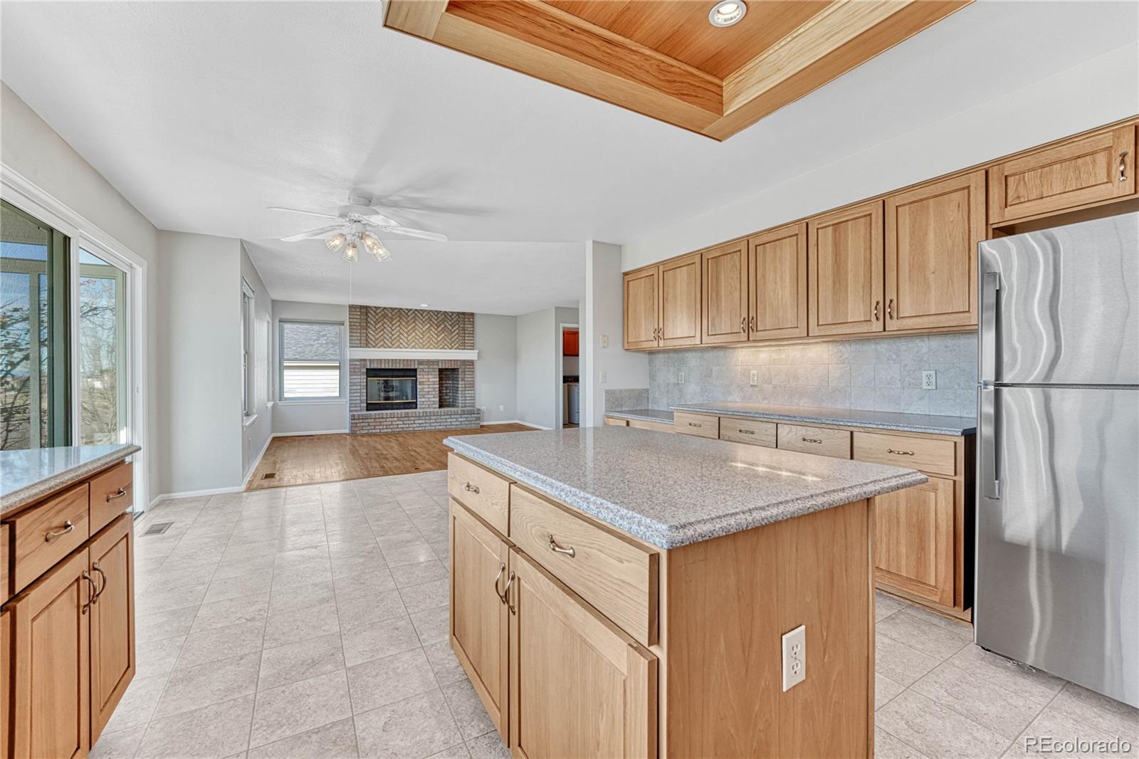 9858 Venneford Ranch Road Highlands Ranch, CO 80126 - Photo 11 of 50 a kitchen with stainless steel appliances granite countertop a sink refrigerator and cabinets