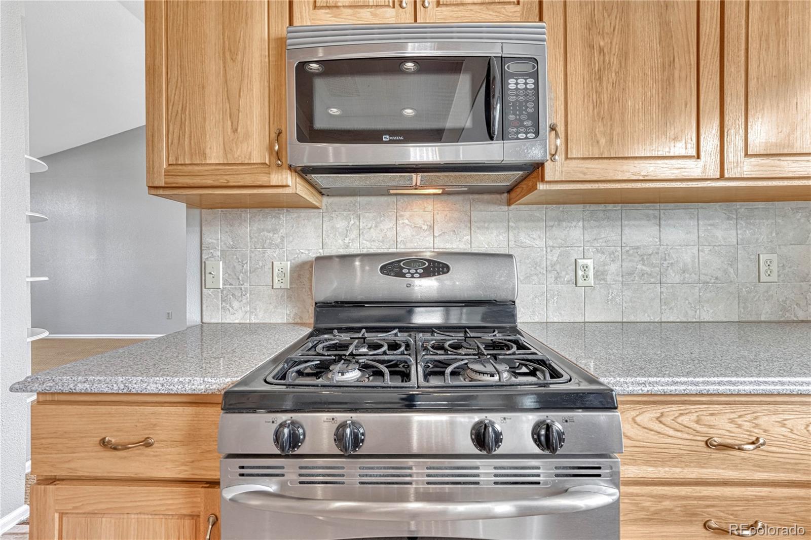 9858 Venneford Ranch Road Highlands Ranch, CO 80126 - Photo 12 of 50 a stove top oven sitting inside of a kitchen