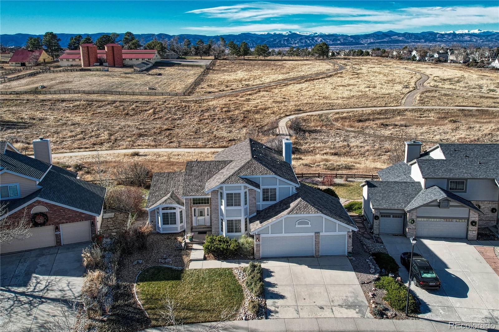 9858 Venneford Ranch Road Highlands Ranch, CO 80126 - Photo 2 of 50 a front view of a house with a yard