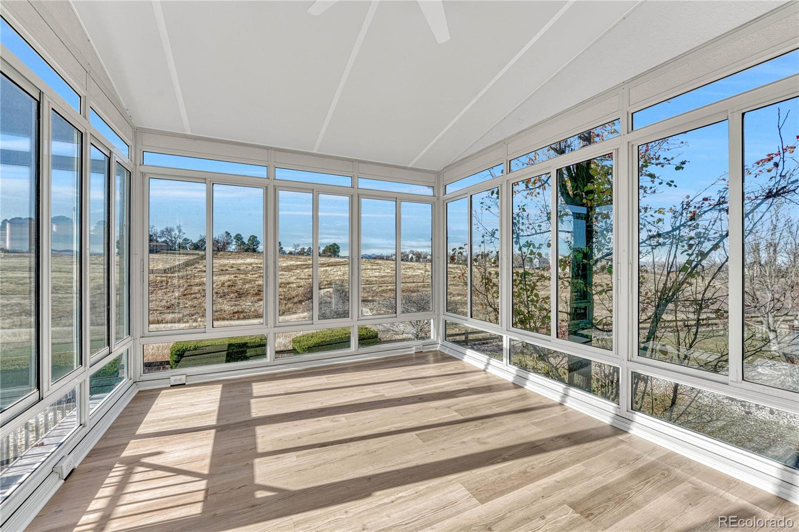 9858 Venneford Ranch Road Highlands Ranch, CO 80126 - Photo 21 of 50 a spacious bedroom with a large window and a balcony