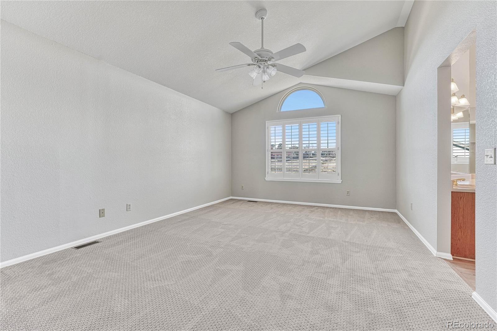 9858 Venneford Ranch Road Highlands Ranch, CO 80126 - Photo 29 of 50 an empty room with a window and a ceiling fan