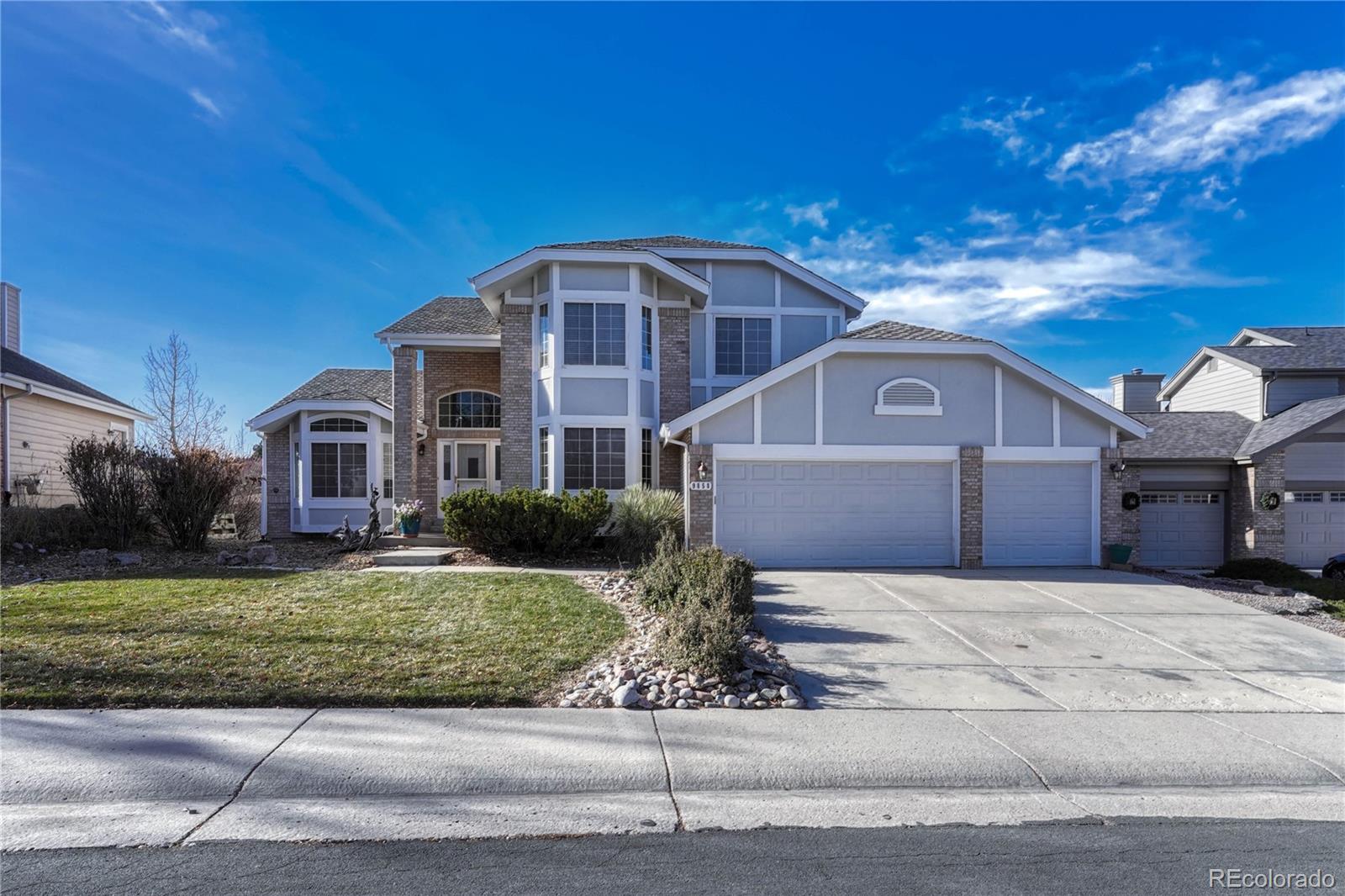 9858 Venneford Ranch Road Highlands Ranch, CO 80126 - Photo 3 of 50 a front view of a house with a yard