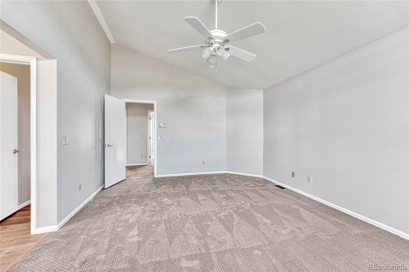 9858 Venneford Ranch Road Highlands Ranch, CO 80126 - Photo 32 of 50 a view of an empty room with a chandelier fan