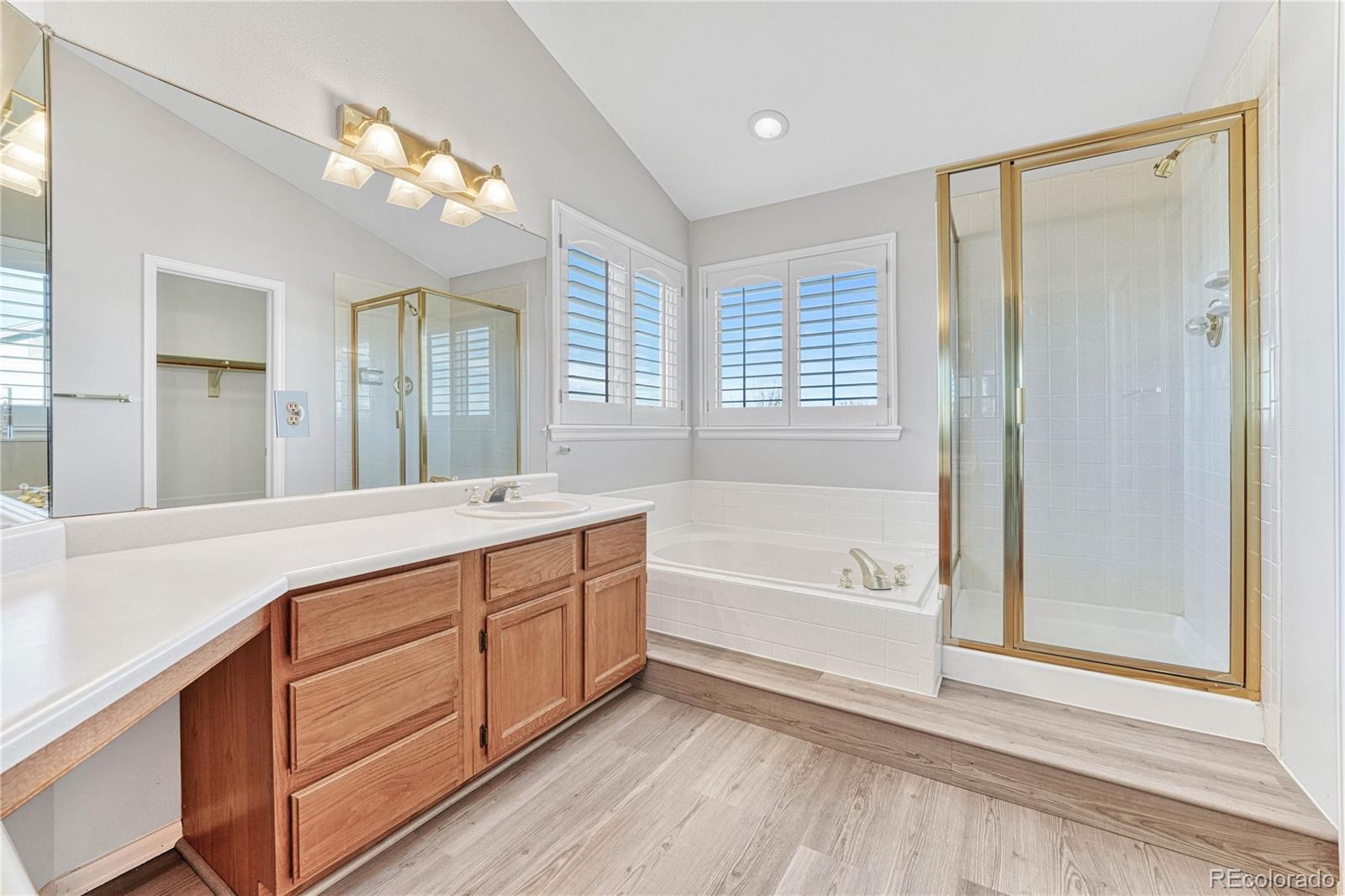 9858 Venneford Ranch Road Highlands Ranch, CO 80126 - Photo 33 of 50 a spacious bathroom with a tub sink and mirror