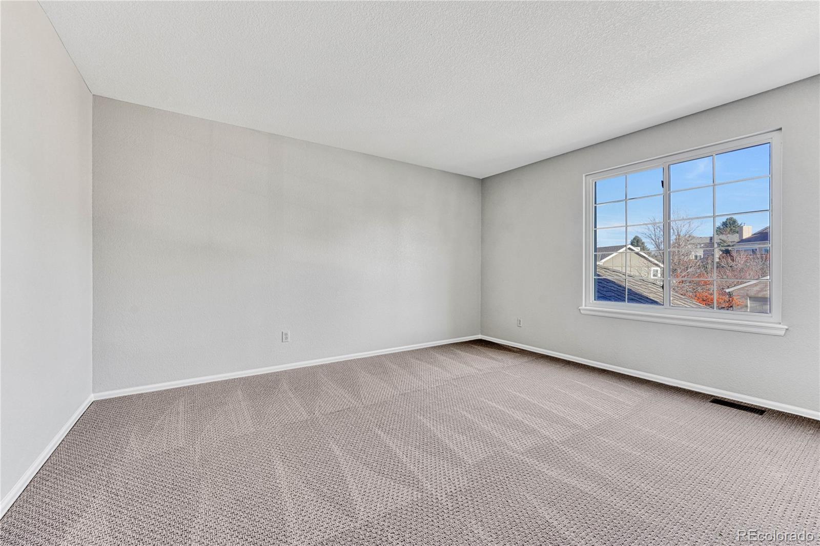 9858 Venneford Ranch Road Highlands Ranch, CO 80126 - Photo 37 of 50 a view of an empty room with a painting on the wall