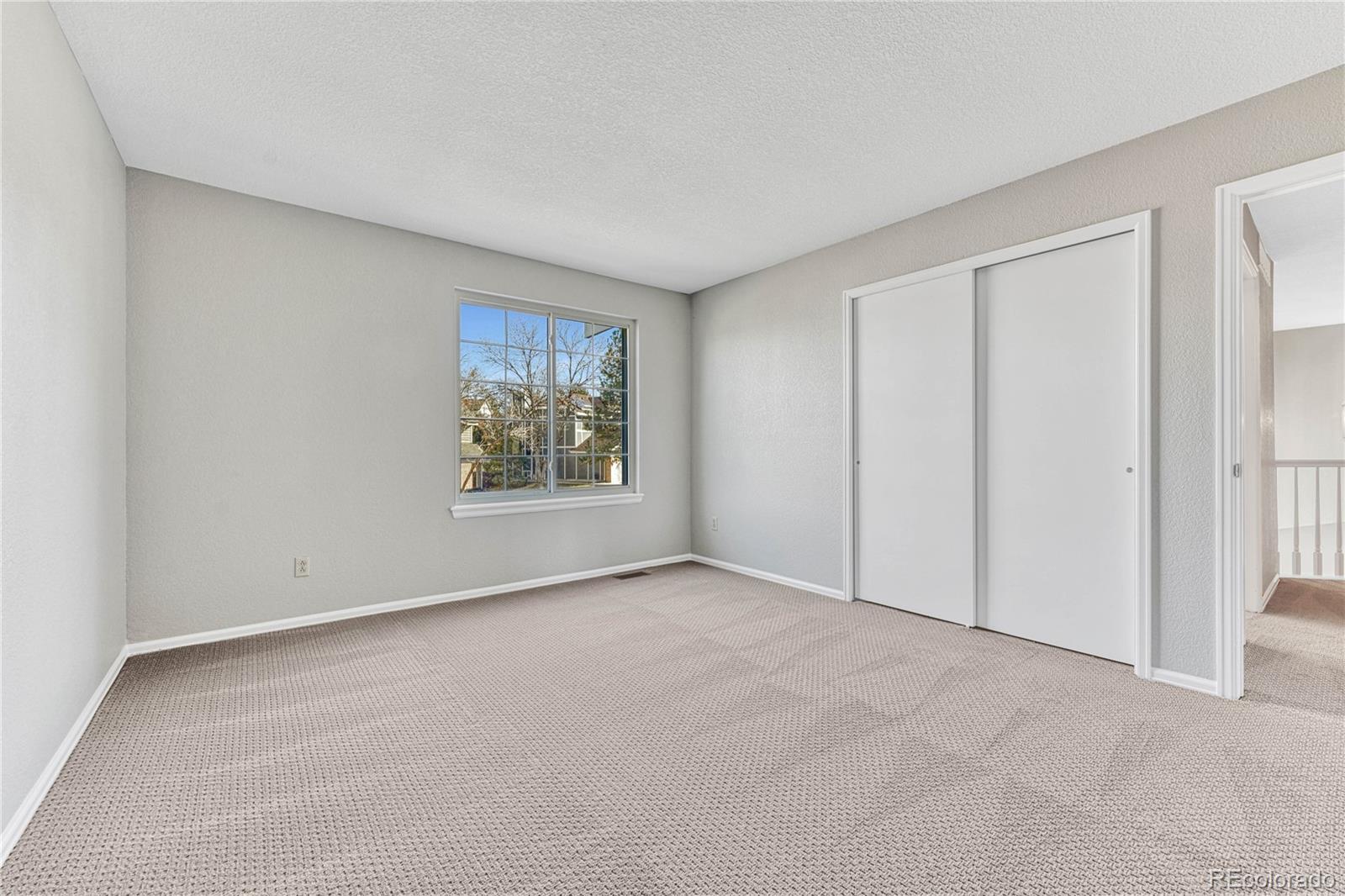 9858 Venneford Ranch Road Highlands Ranch, CO 80126 - Photo 38 of 50 an empty room with windows and closet