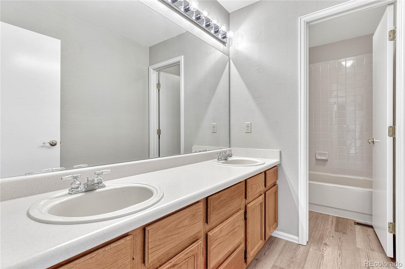 9858 Venneford Ranch Road Highlands Ranch, CO 80126 - Photo 39 of 50 a bathroom with a sink and a mirror