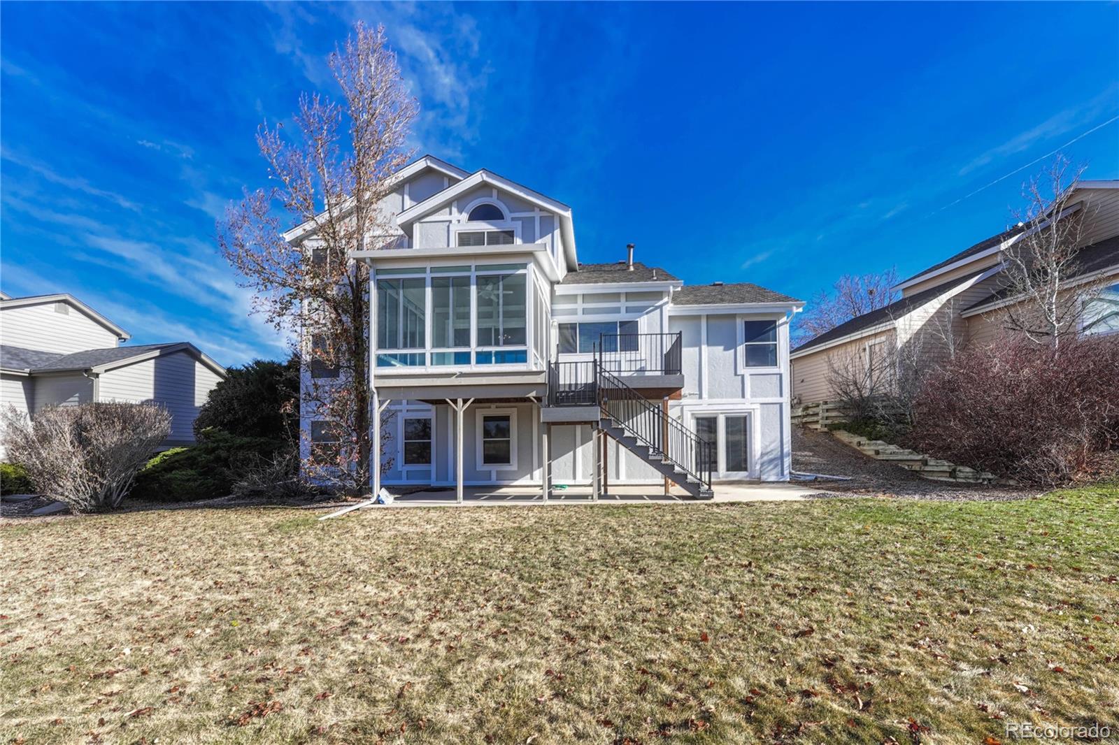 9858 Venneford Ranch Road Highlands Ranch, CO 80126 - Photo 42 of 50 a front view of a house with a yard