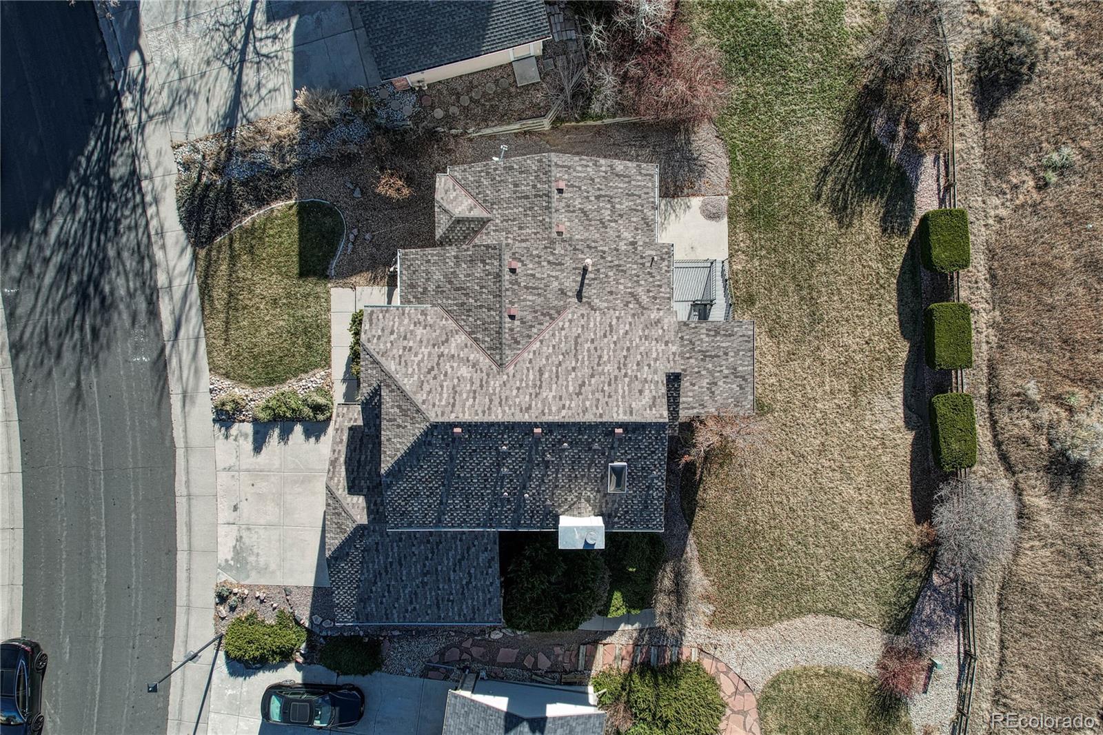 9858 Venneford Ranch Road Highlands Ranch, CO 80126 - Photo 45 of 50 a aerial view of a house with a yard and large tree