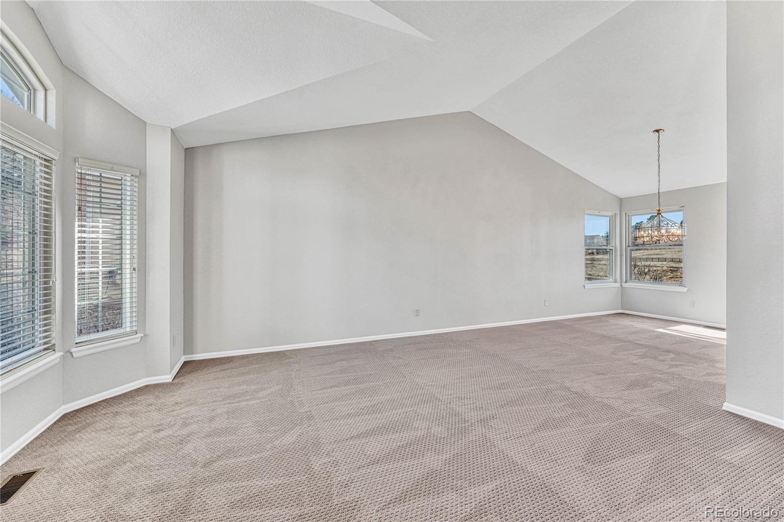 9858 Venneford Ranch Road Highlands Ranch, CO 80126 - Photo 7 of 50 a view of an empty room with a window