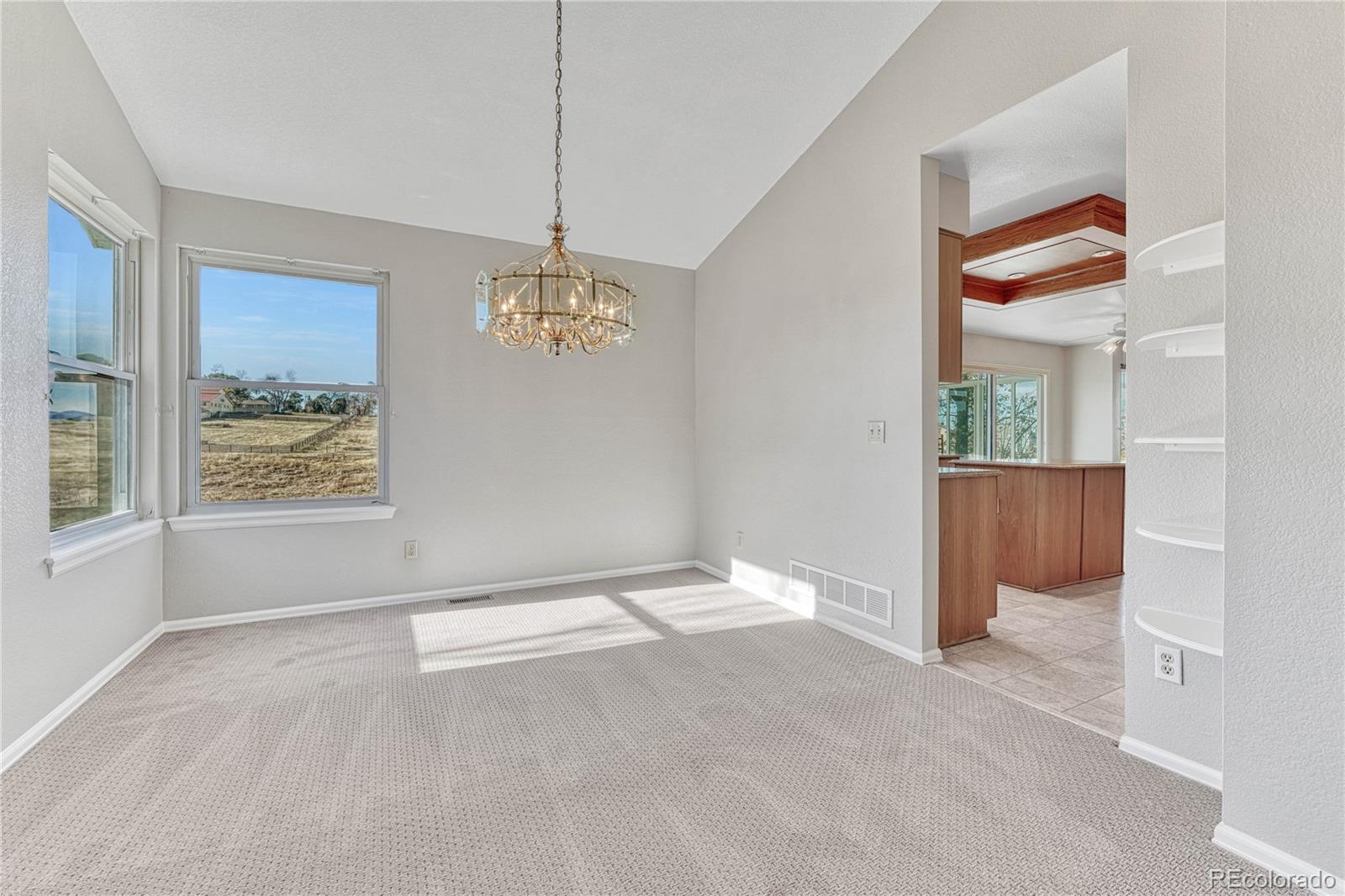 9858 Venneford Ranch Road Highlands Ranch, CO 80126 - Photo 9 of 50 a view of an empty room with a window