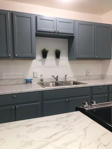 a kitchen with a sink and cabinets