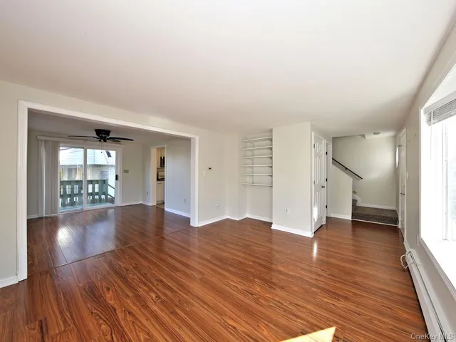 wooden floor in an empty room with a window