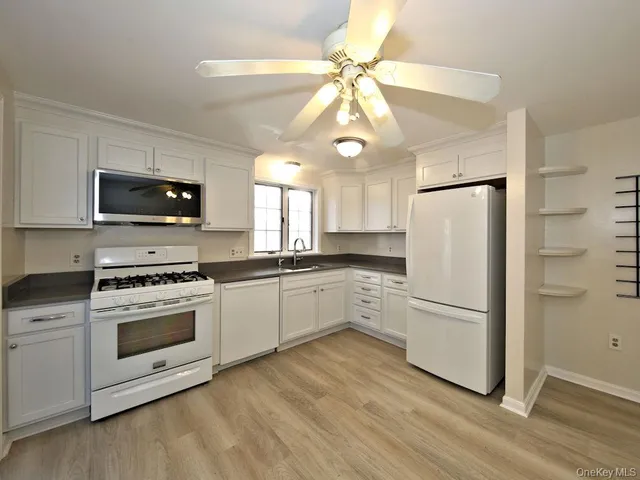 a kitchen with a refrigerator stove and microwave