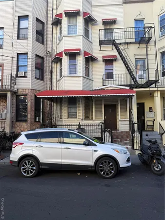 a view of a car parked in front of a building