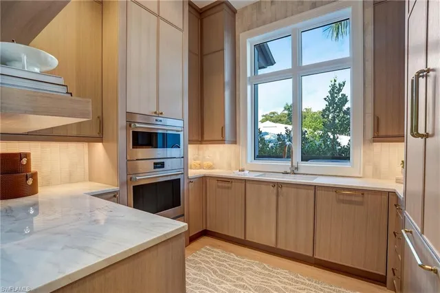 a kitchen with stainless steel appliances a sink and a stove