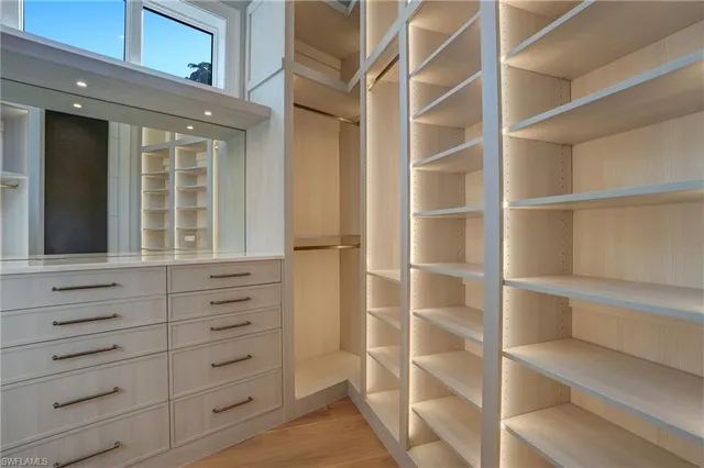 a view of walk in closet with empty racks