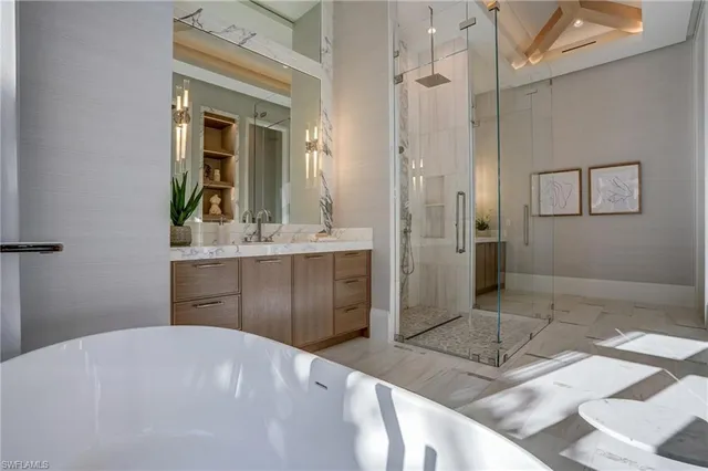 a bathroom with a sink a mirror and a shower