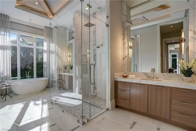 a spacious bathroom with a double vanity sink a large mirror and a shower