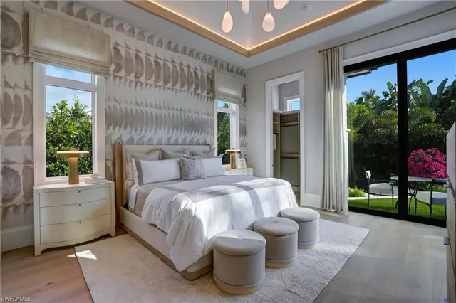 a bedroom with a bed and a potted plant