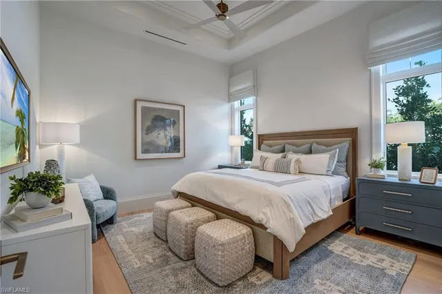 a bedroom with a bed and a potted plant