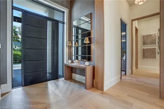a view of a kitchen with furniture and wooden floor
