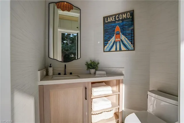 a bathroom with a toilet a sink and a mirror