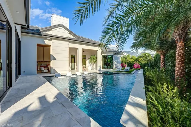 a view of a patio with couches table and chairs and potted plants