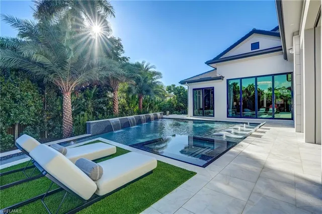 a view of a house with pool and a yard