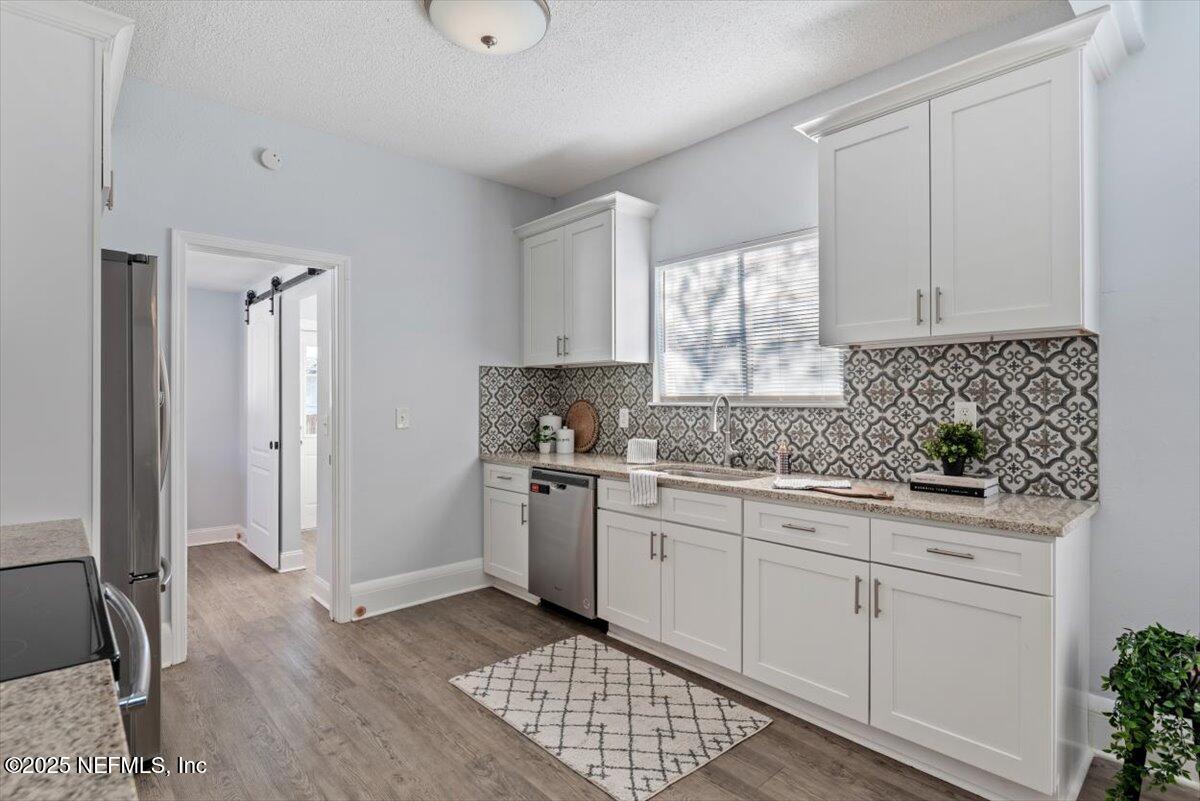 933 Talbot Avenue Jacksonville, FL 32205 - Photo 13 of 41 a kitchen with granite countertop white cabinets and white appliances