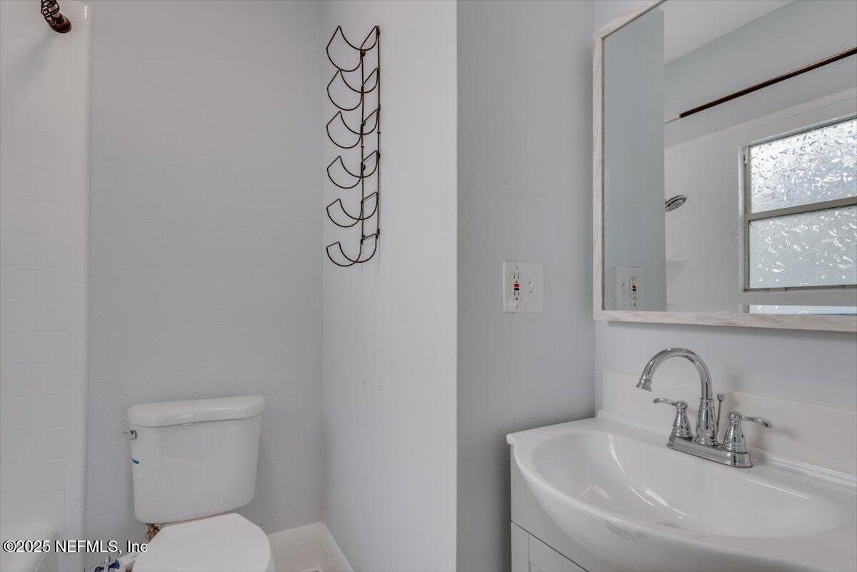 933 Talbot Avenue Jacksonville, FL 32205 - Photo 19 of 41 a bathroom with a toilet sink and window