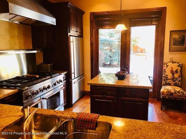 a kitchen with stainless steel appliances granite countertop a stove and a refrigerator