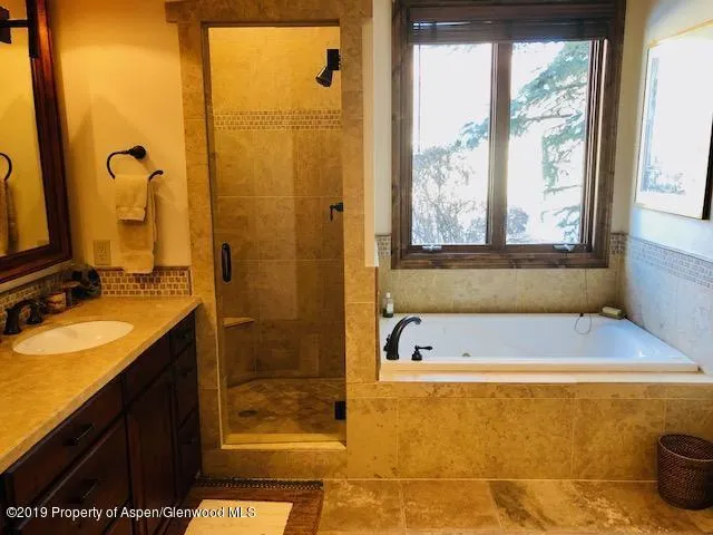a bathroom with a tub sink and window