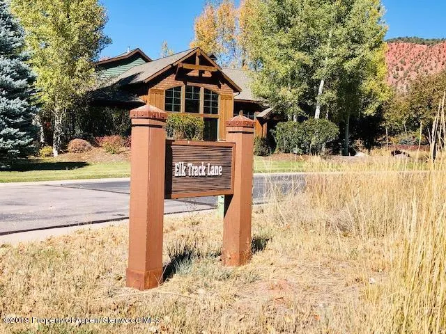 a view of a house with a wooden fence