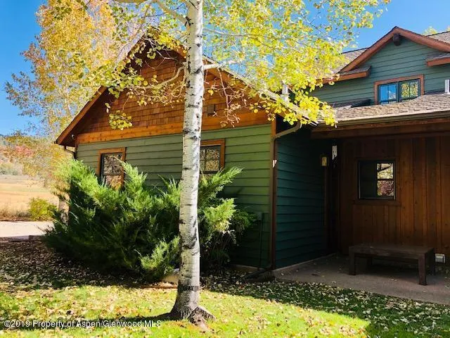 a wooden bench sitting in front of a building