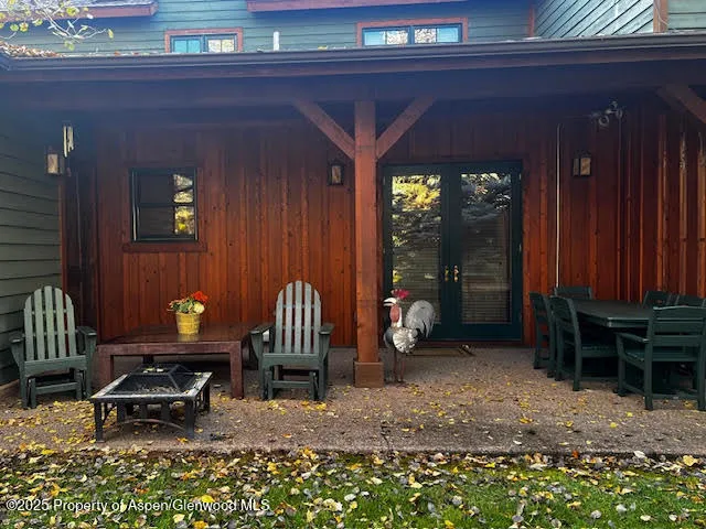 a balcony with furniture and large windows