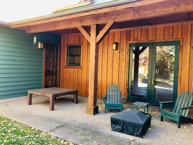 a backyard of a house with outdoor seating