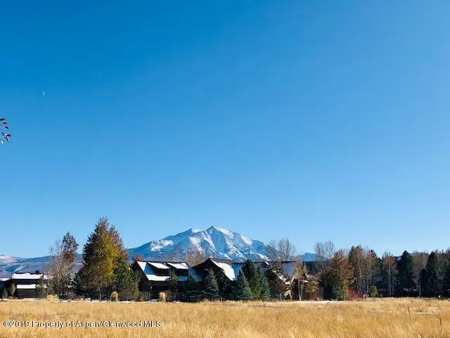 a view of ocean with a building in the background