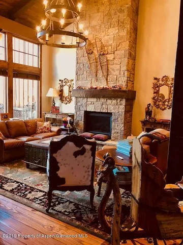 a living room with furniture a fireplace and a table