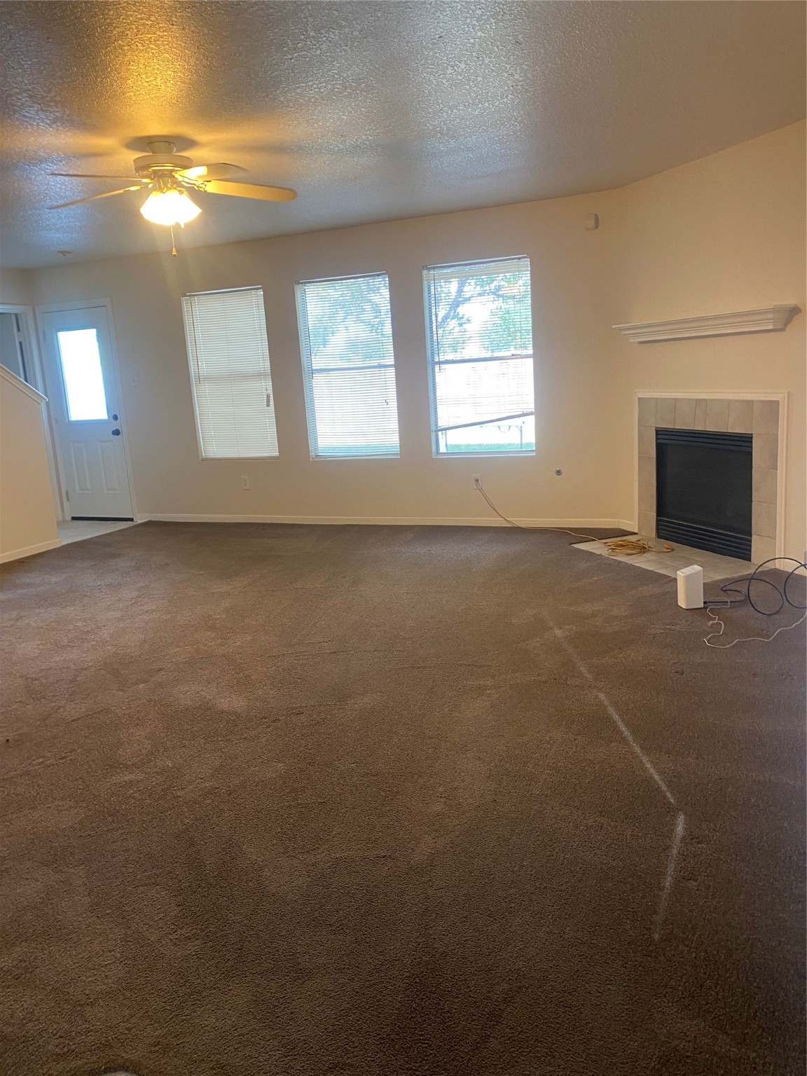 16302 Embry Hills Drive Houston, TX 77073 - Photo 11 of 16 a view of an empty room with window and fireplace