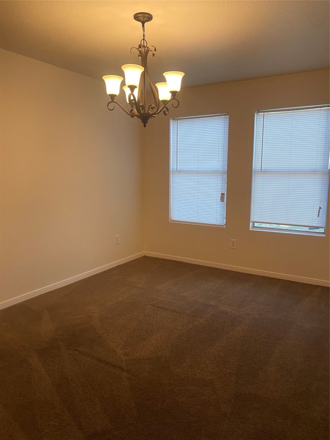 16302 Embry Hills Drive Houston, TX 77073 - Photo 13 of 16 a view of a chandelier fan and window in an empty room