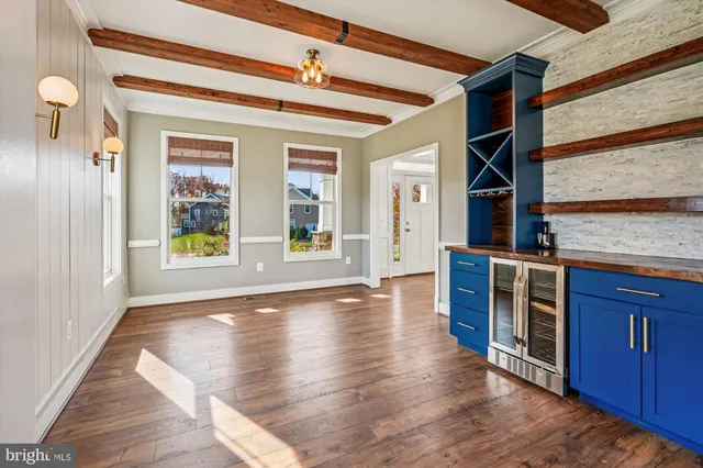 a view of a room with wooden floor and ceiling fan