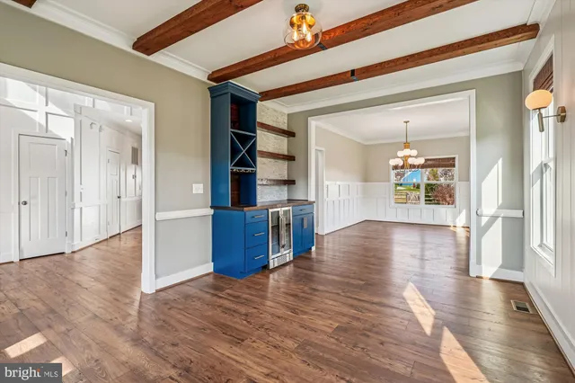 a view of a room with wooden floor and white walls
