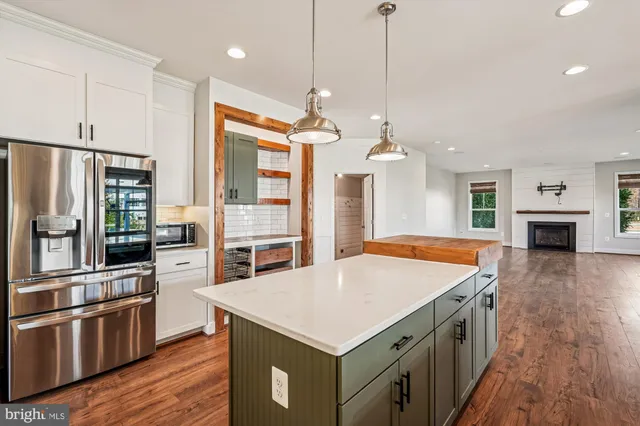 a view of hallway with stairs and wooden floor