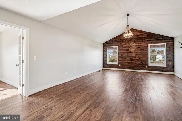 a swimming pool with lots of tress in front of it