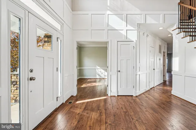 a kitchen with stainless steel appliances granite countertop a kitchen island a stove a refrigerator a oven and a fireplace