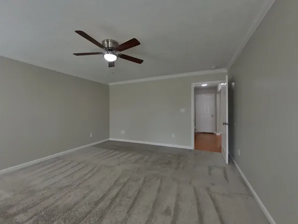 a view of empty room with a ceiling fan