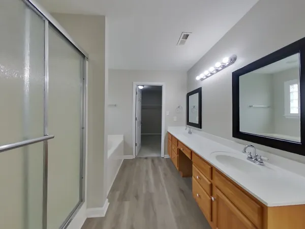 a bathroom with a double vanity sink and a mirror