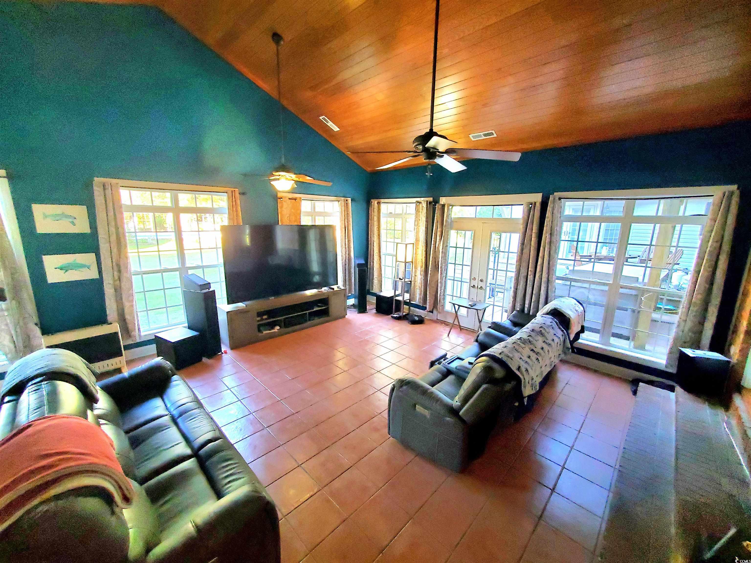 1484 Fitch Road Lake City, SC 29560 - Photo 16 of 40 Tiled living room with high vaulted ceiling, wooden ceiling, and french doors